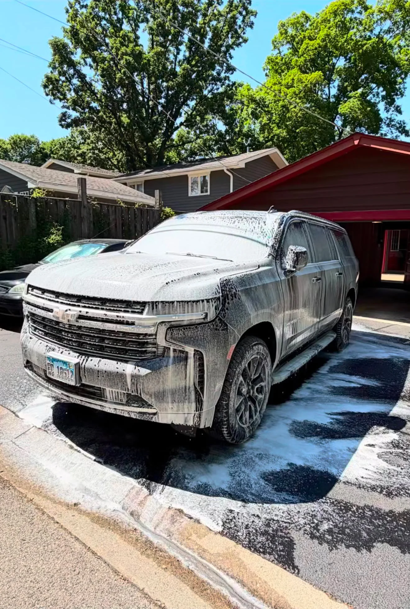 Chevrolet SUV receiving a foaming wash